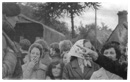 Newry women castigate British soldiers at the UDR centre, while at the rear, internees prepare to board an army lorry en route to Long Kesh or the Prison Ship Maidstone.